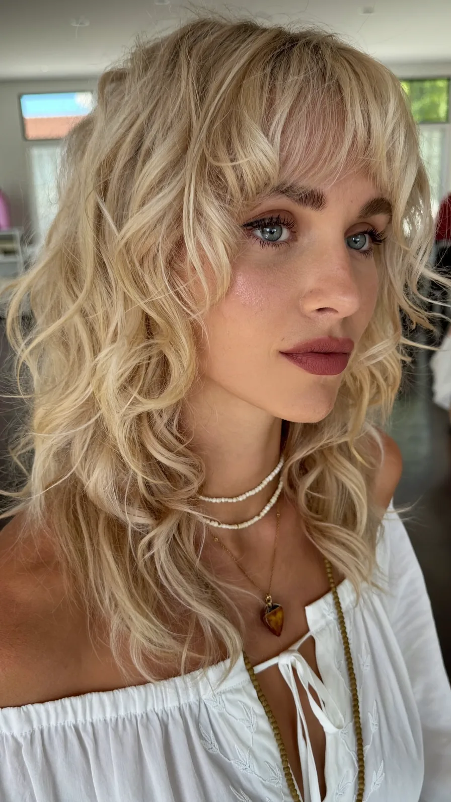 Voluminous Textured Blonde Shag with Wispy Curtain Bangs