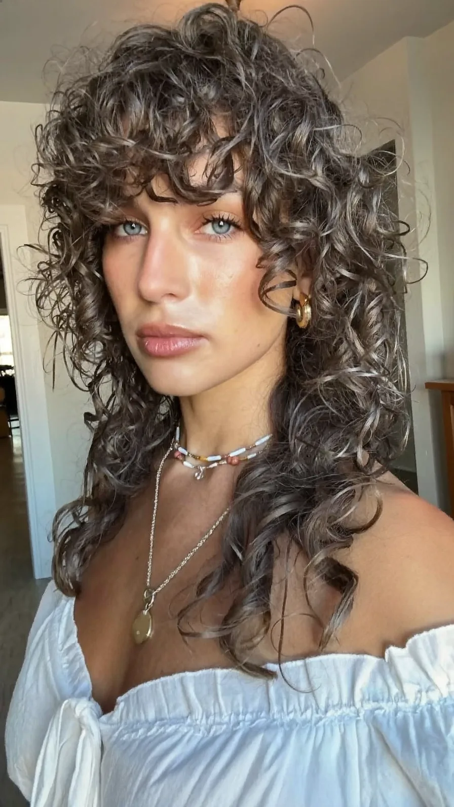 Voluminous Curly Shag Hairstyle with Soft Curtain Bangs
