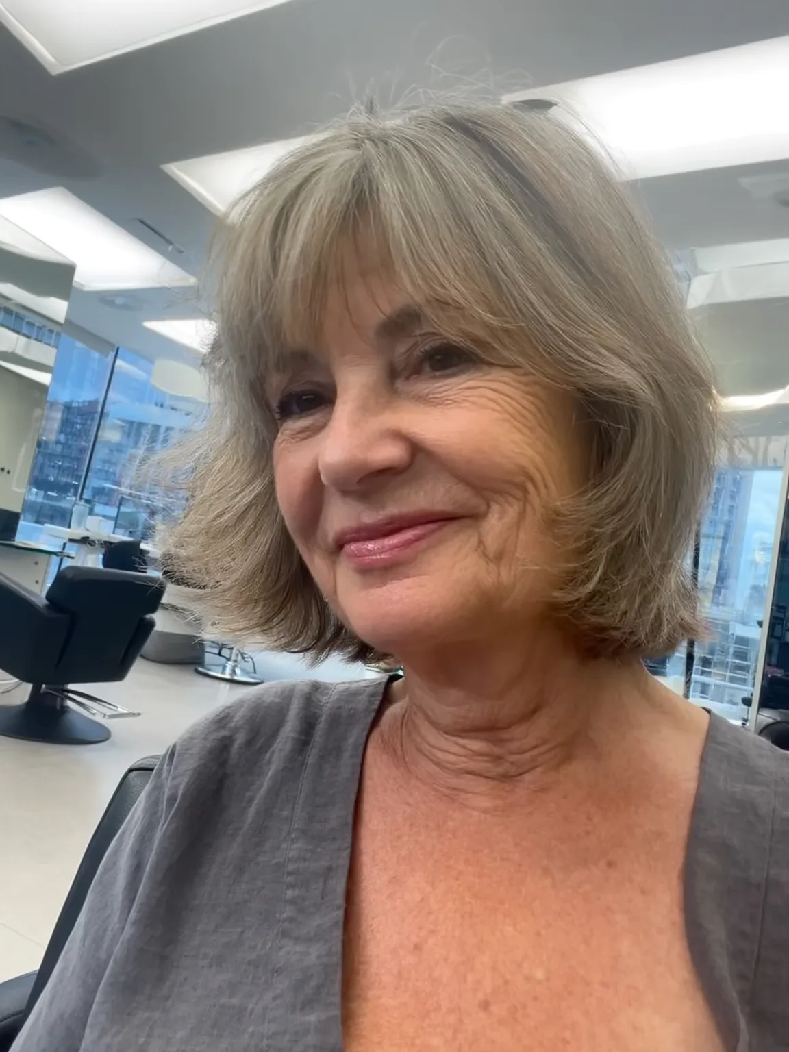 Soft Ash Gray Wavy Chin-Length Bob with Wispy Bangs
