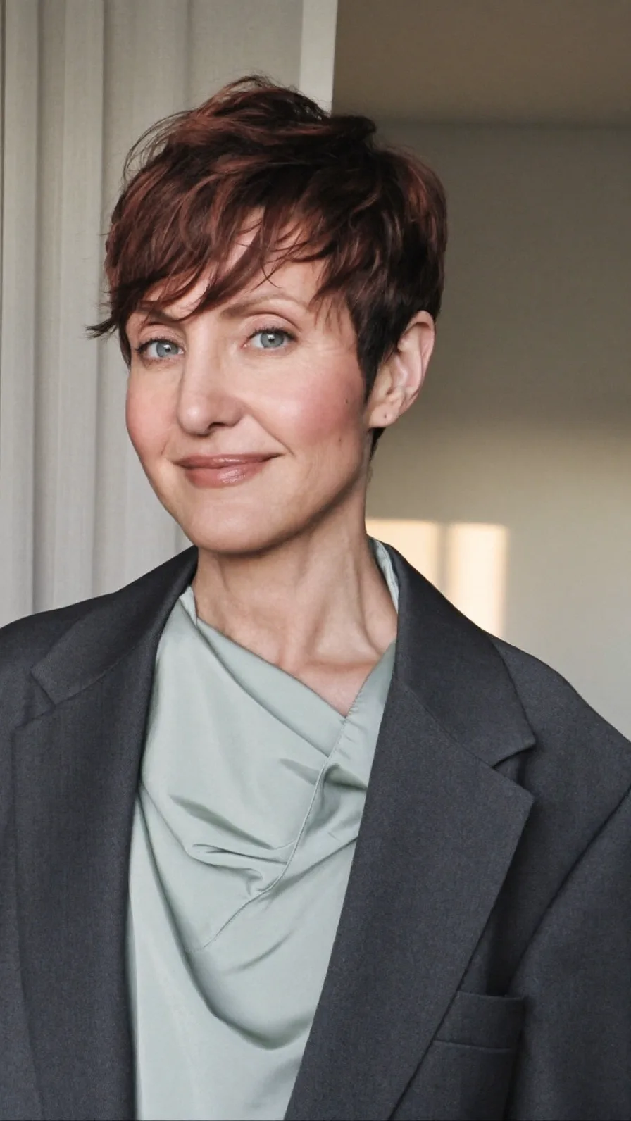 Elegant Textured Auburn Pixie with Side-Swept Bangs