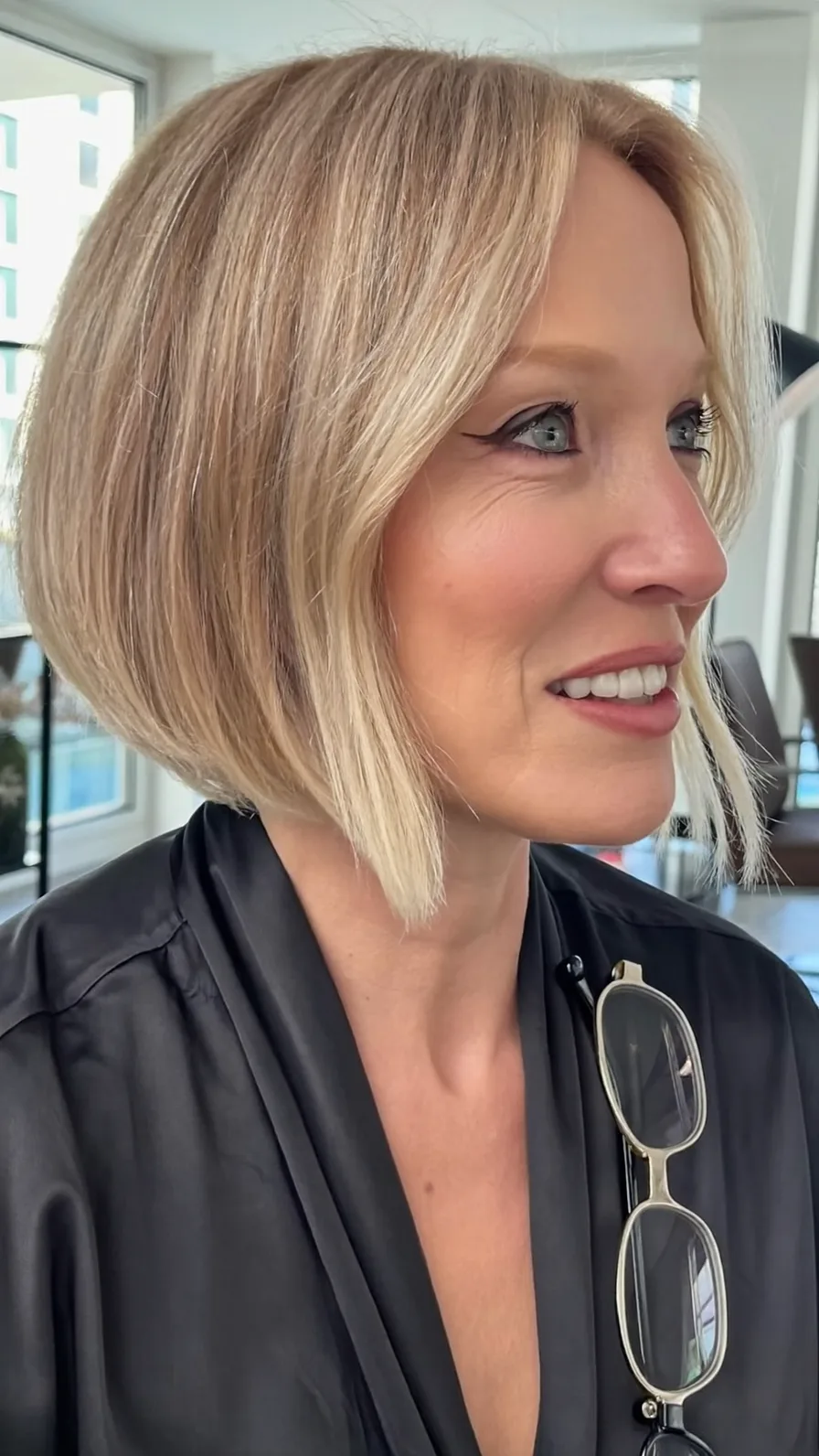 Chic Inverted Bob with Curtain Bangs and Warm Ash Blonde Highlights