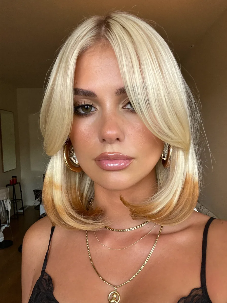 Sleek platinum blonde blunt bob with curtain bangs