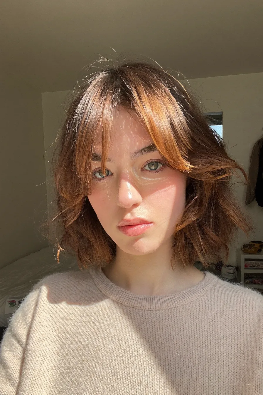 Chic Layered Bob with Curtain Bangs and Feathered Ends