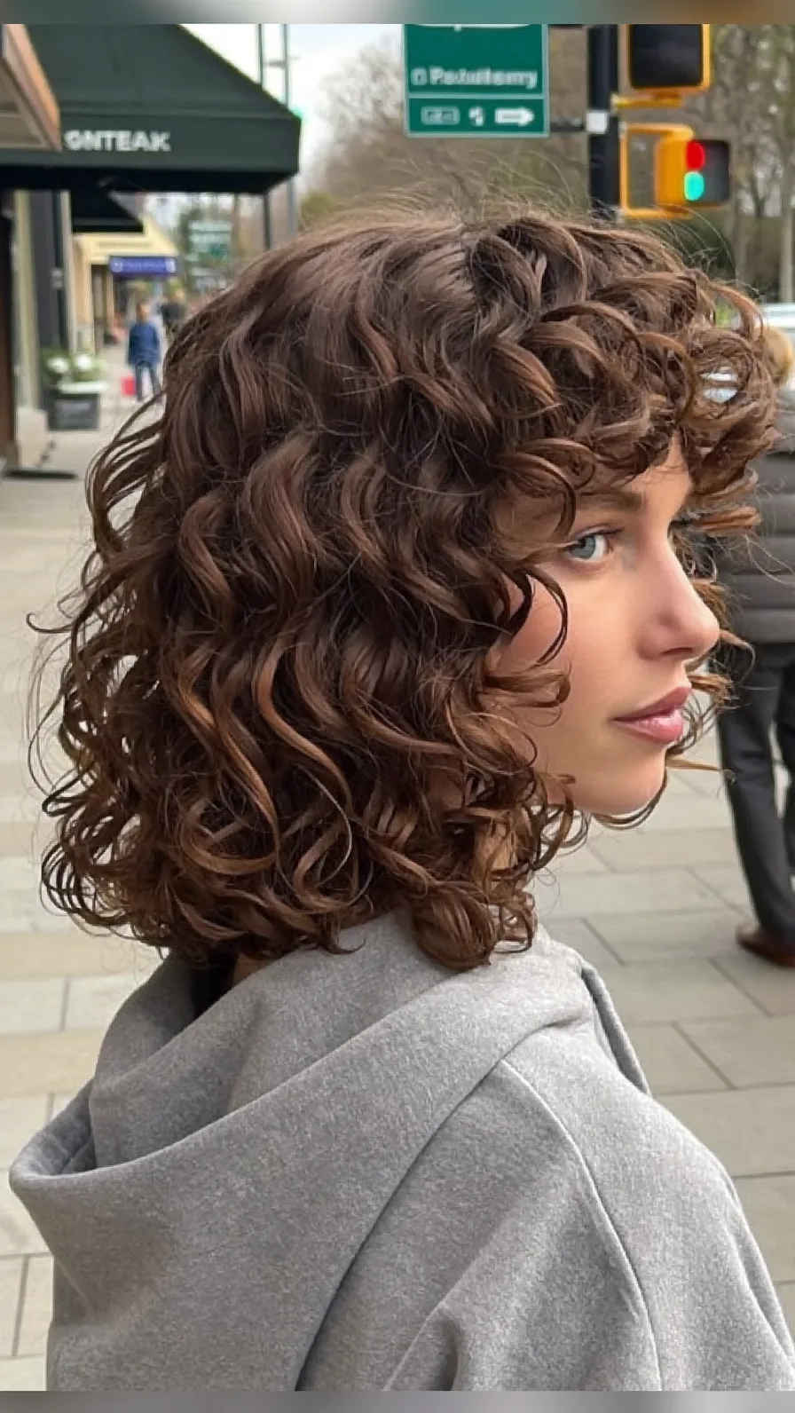 Voluminous Chin-Length Curly Bob with Curtain Bangs