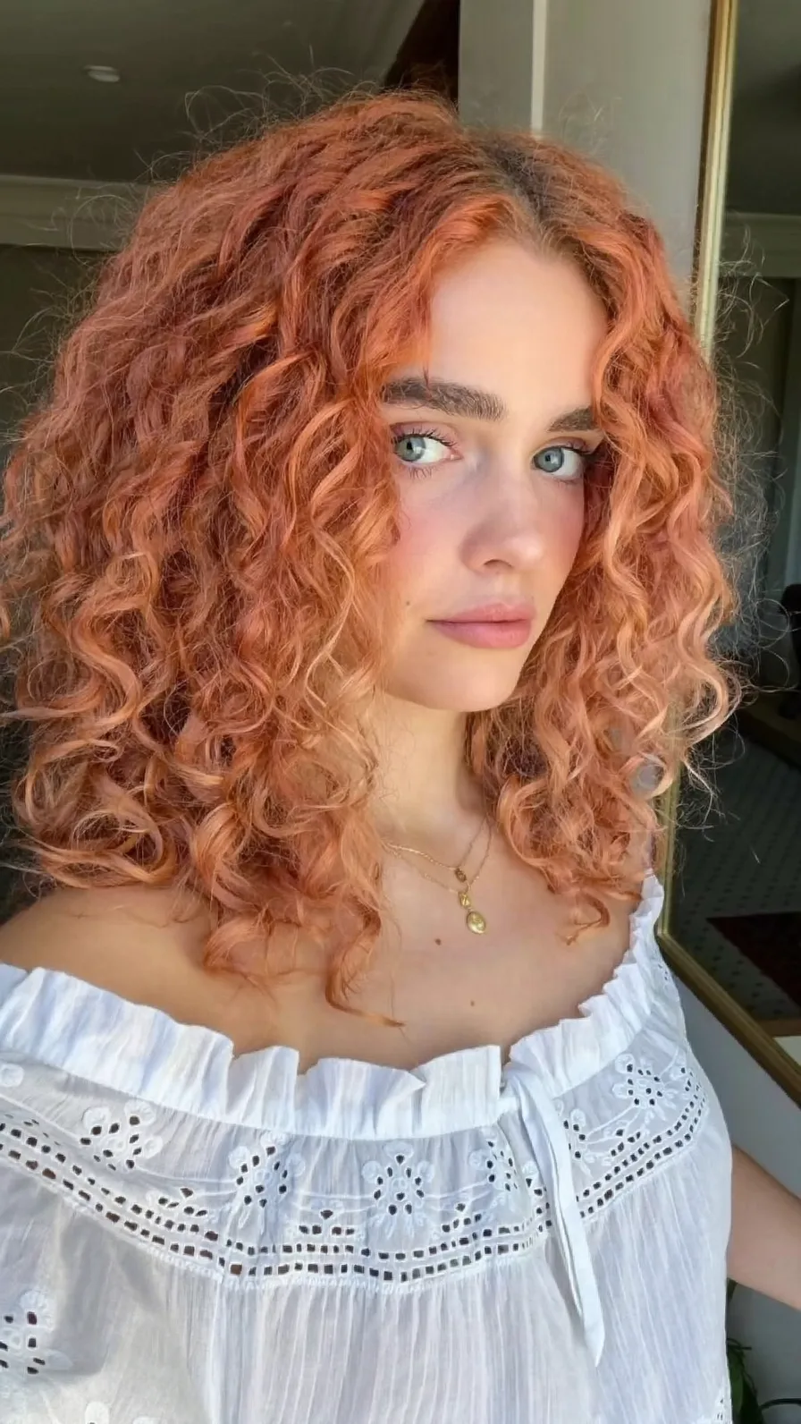 Voluminous Curly Shoulder-Length Copper Rose Gold Hairstyle