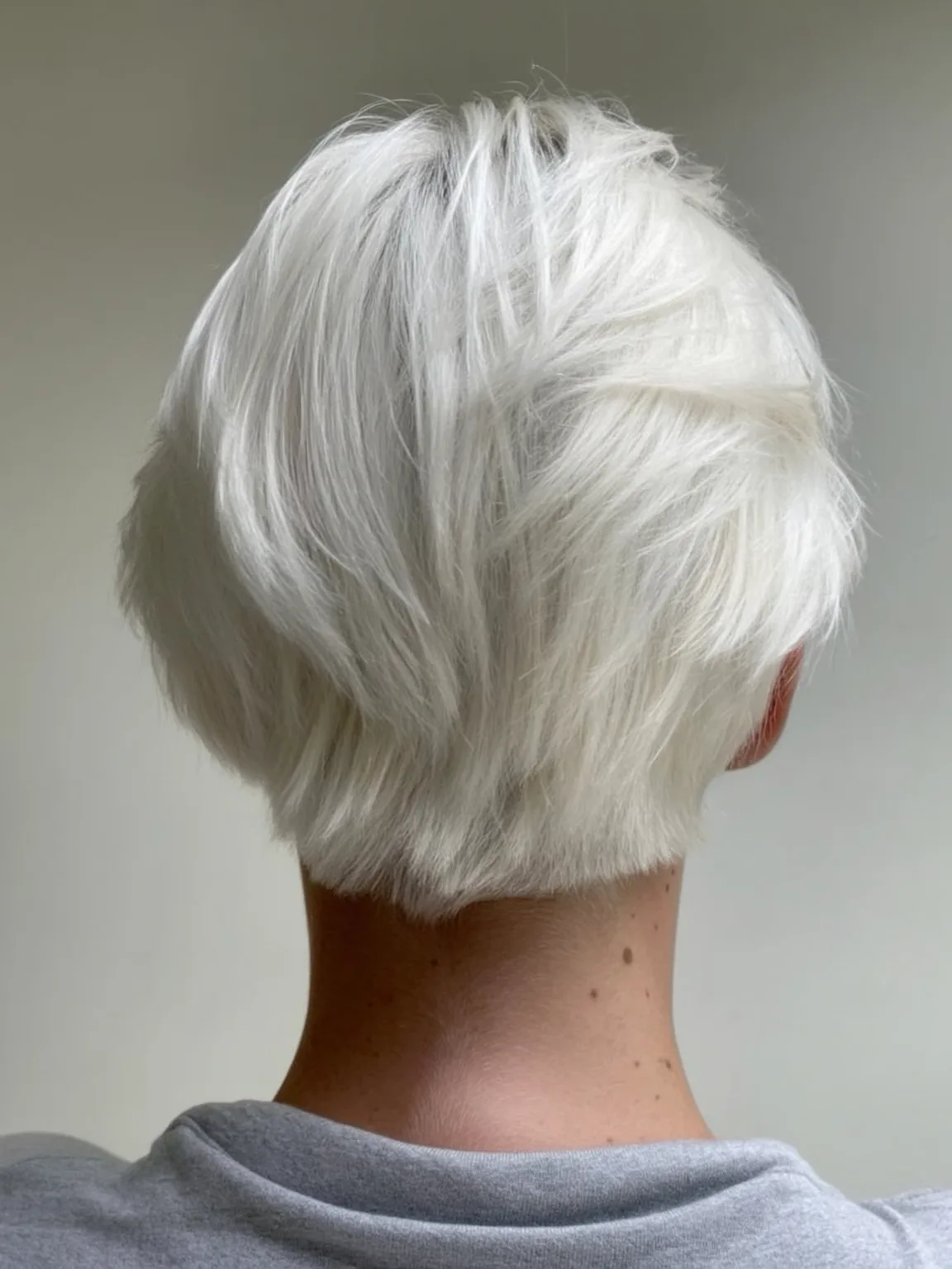 Smooth Platinum Blonde Pixie Without Bangs and Medium Volume