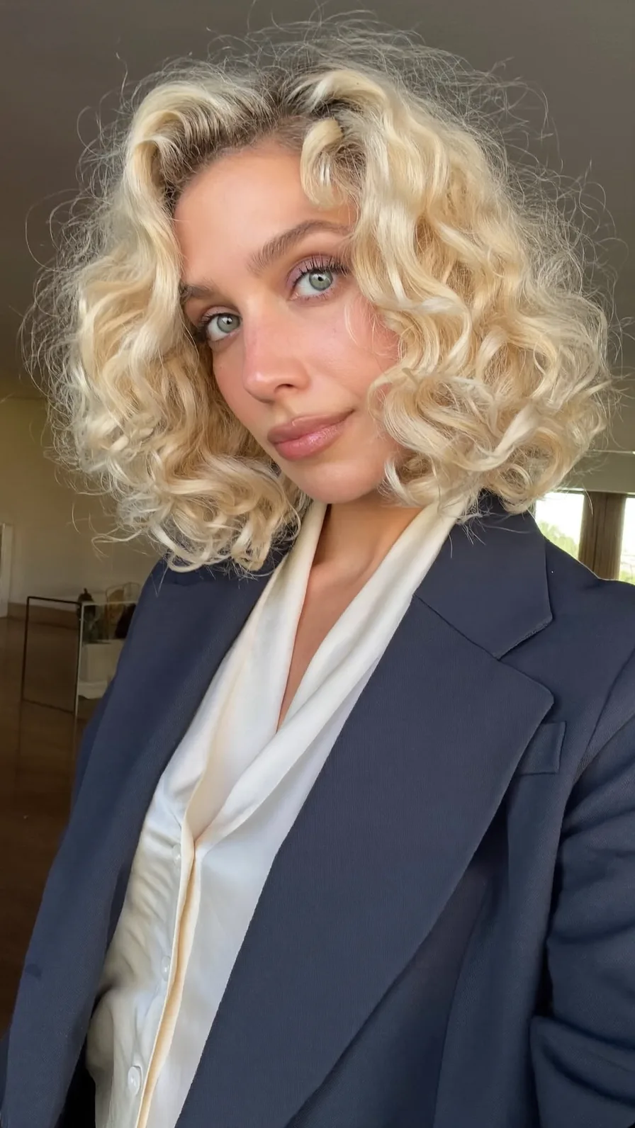 Voluminous Chin-Length Curly Bob with Platinum Blonde Color