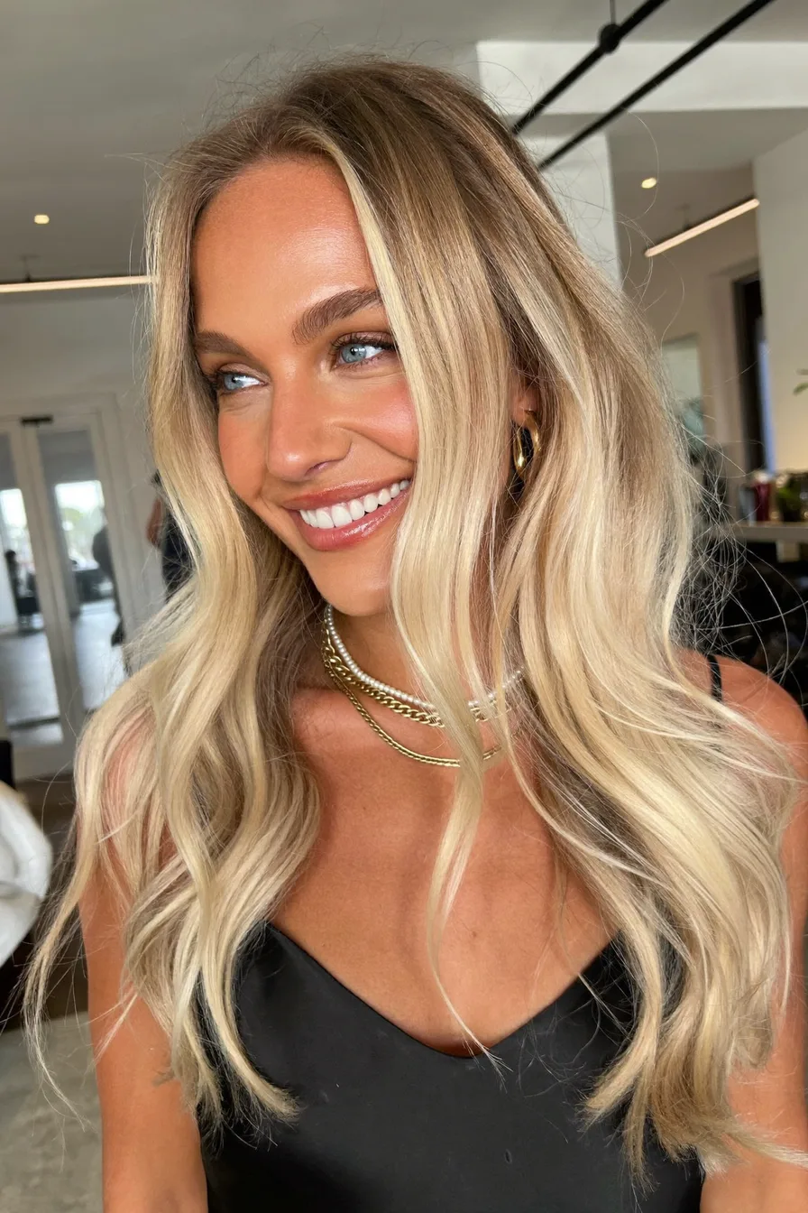 Voluminous Long Layers with Cool Platinum Balayage and Curtain Bangs