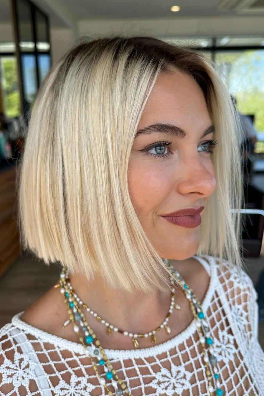 Chic Blunt Bob with Side-Swept Bangs and Cool Blonde