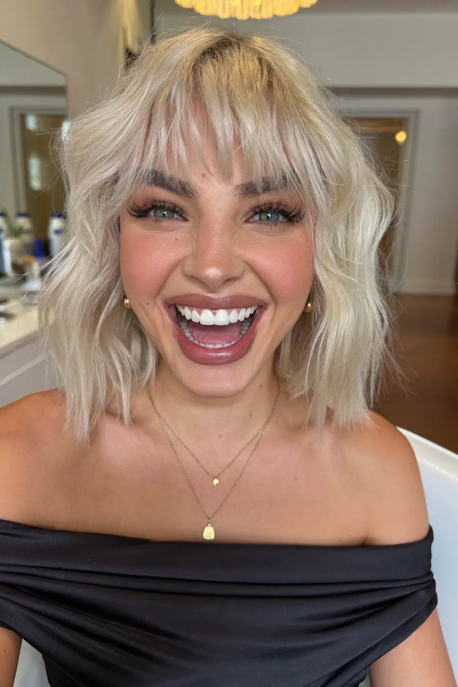 Textured Wavy Bob with Curtain Bangs in Platinum Blonde