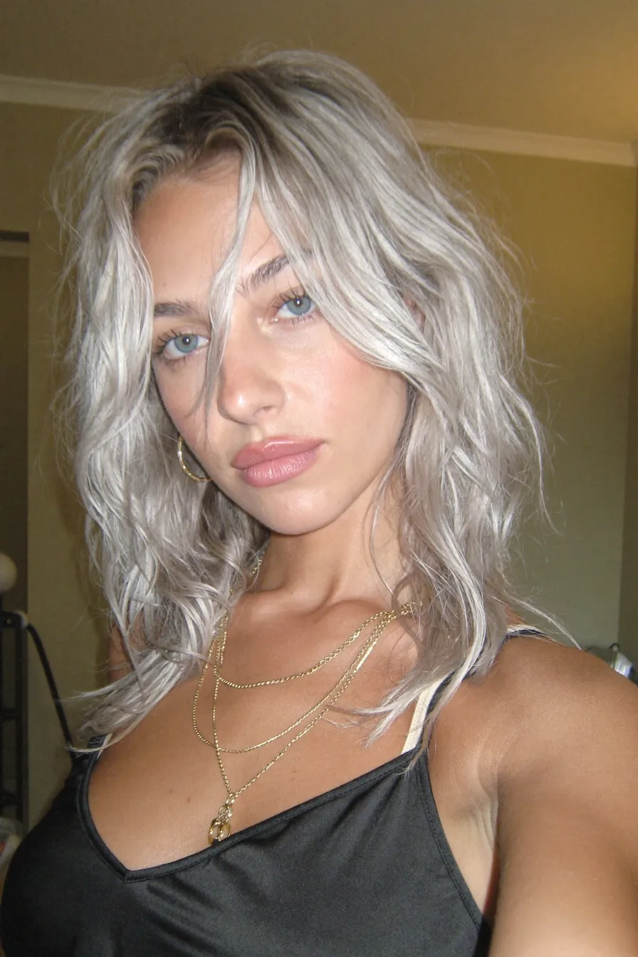 Modern Textured Lob with Icy Platinum Blonde Waves and Curtain Bangs