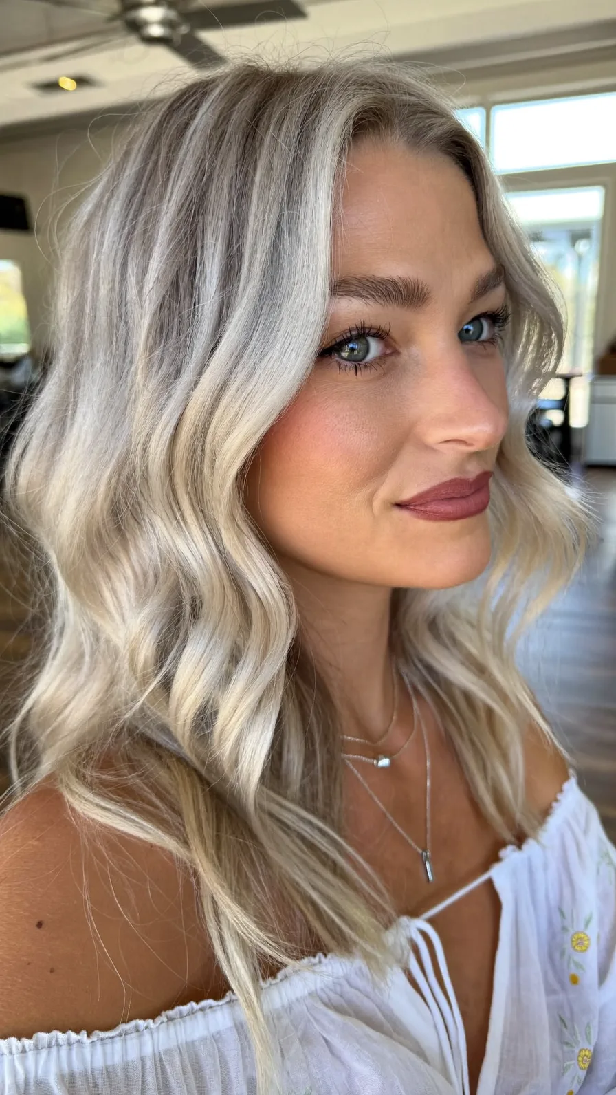 Medium Length Platinum Blonde Flowing Layered Waves Hairstyle