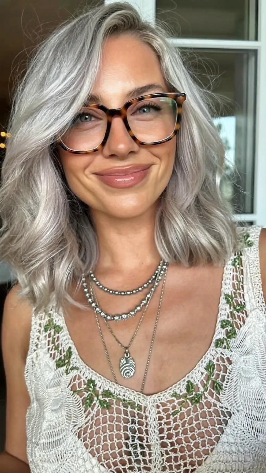 Modern Platinum Silver Shoulder-Length Lob With Side-Swept Bangs