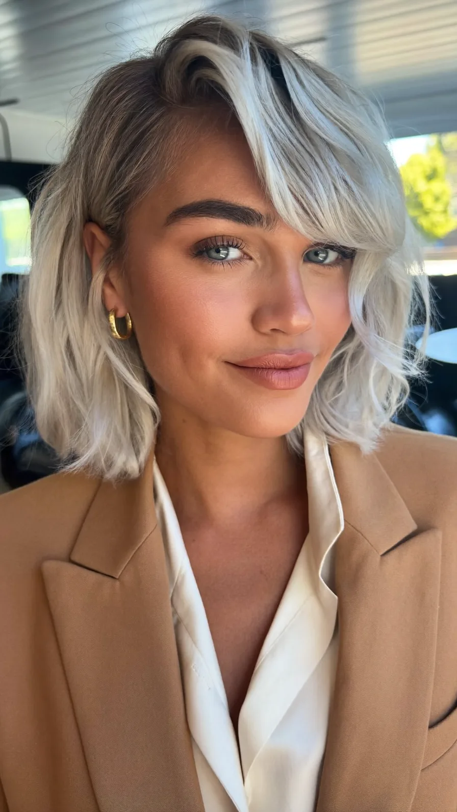 Textured Shoulder-Length Lob with Side-Swept Platinum Blonde Bangs