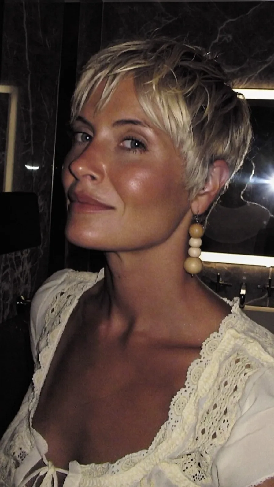 Textured Platinum Blonde Pixie with Side-Swept Bangs