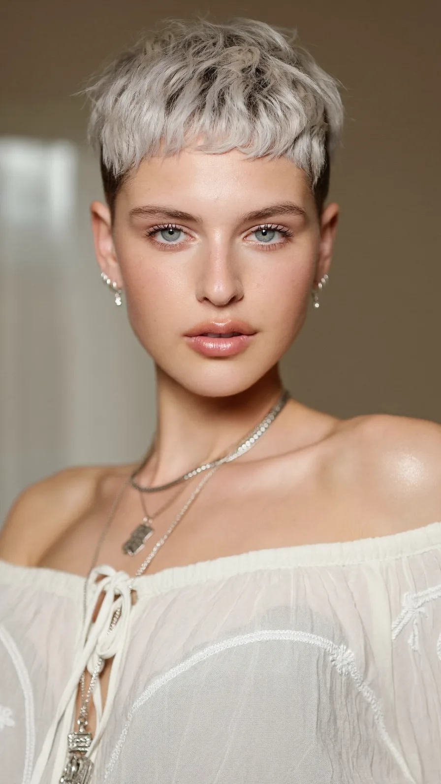 Textured Platinum Blonde Pixie with Micro Bangs and Choppy Ends