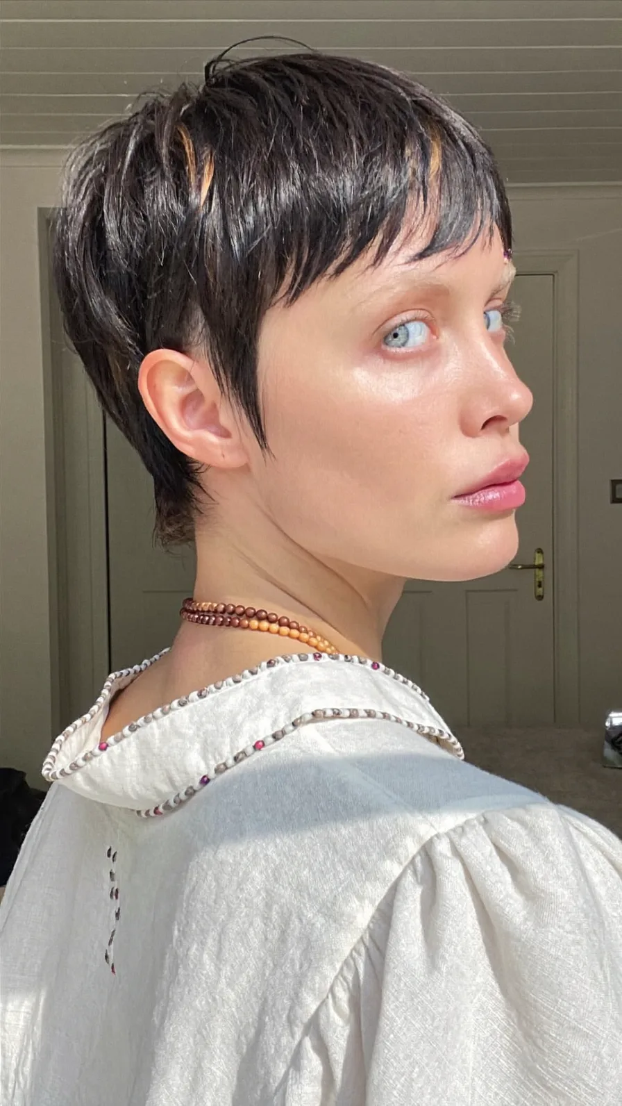 Edgy Textured Pixie Cut with Micro Bangs and Subtle Highlights