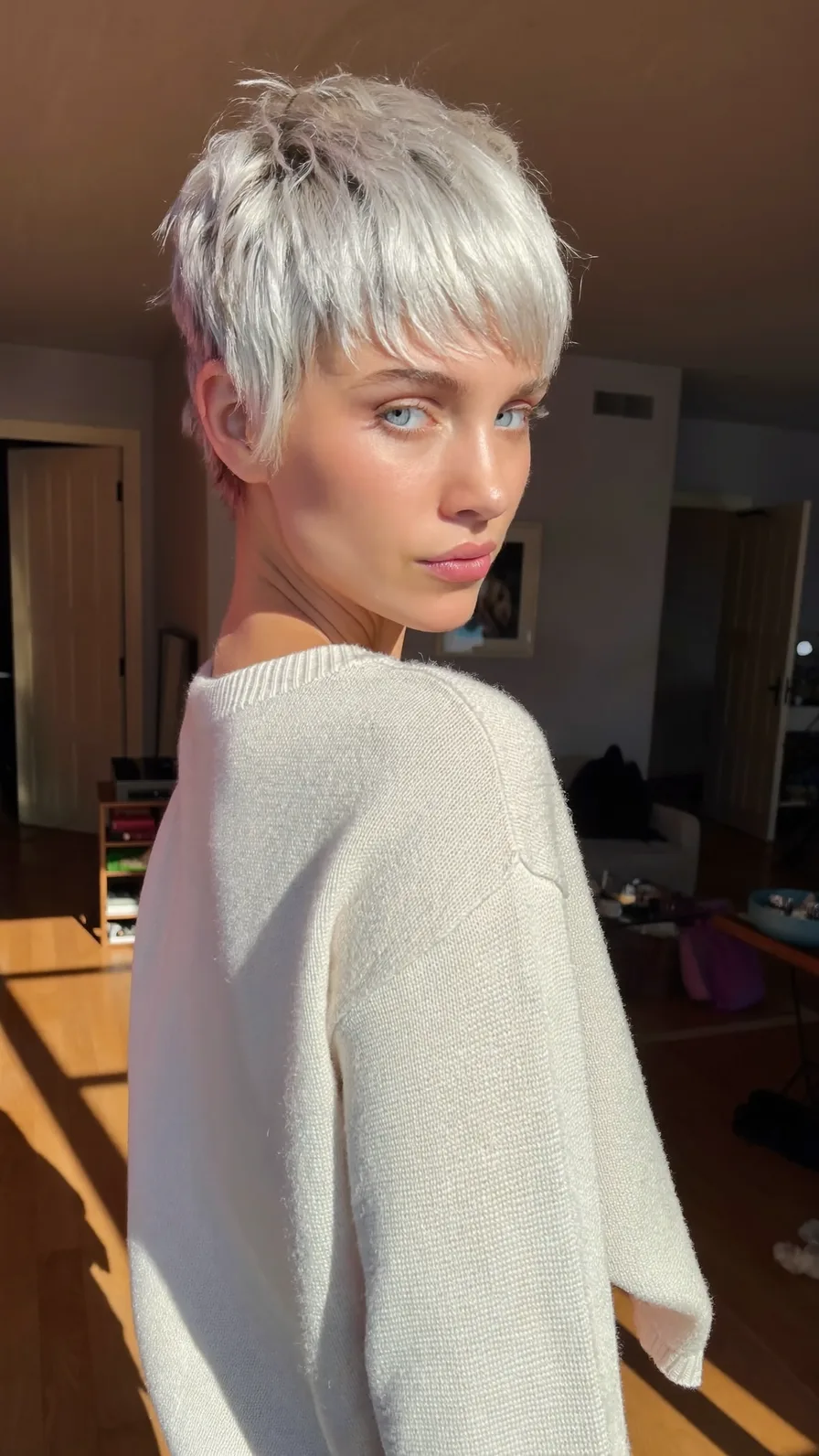 Textured Icy Platinum Blonde Razor-Cut Pixie with Long Bangs