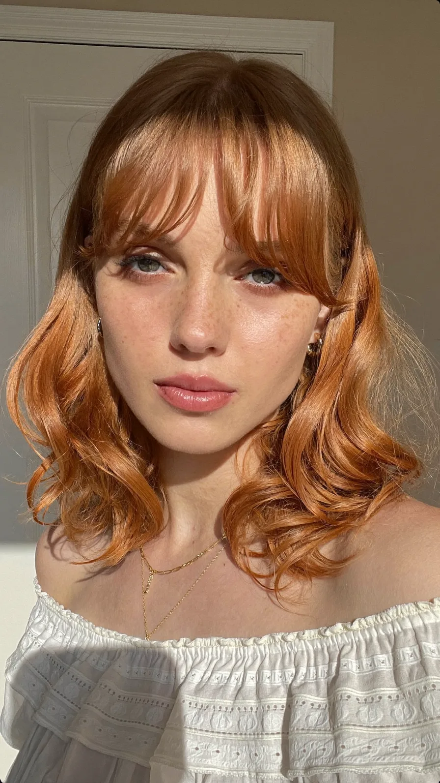Soft Copper Shoulder-Length Hair with Flowing Curtain Bangs