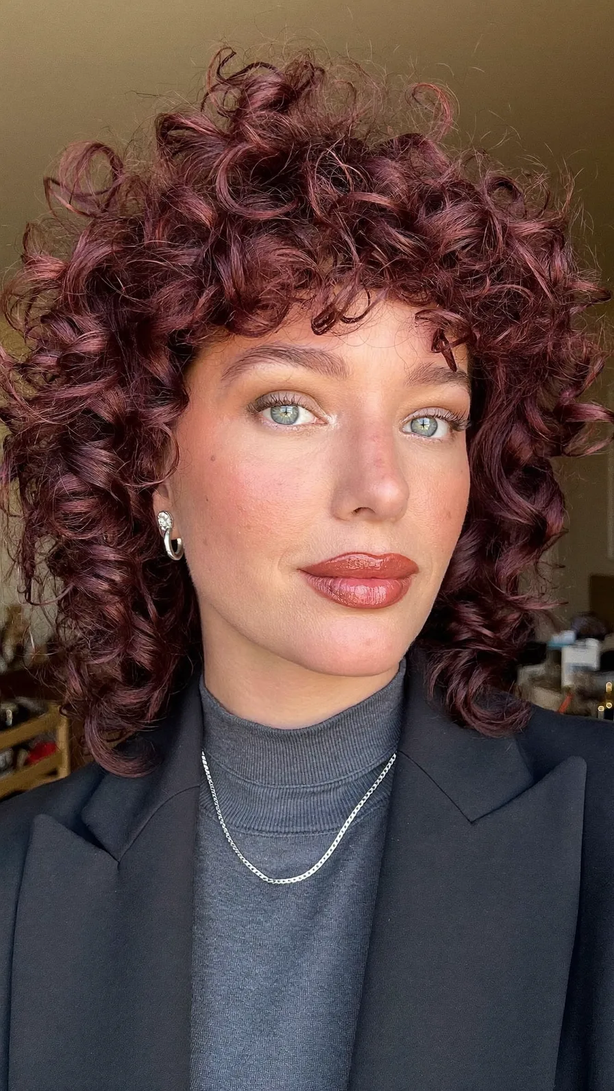 Voluminous Shoulder-Length Curly Bob with Curtain Bangs
