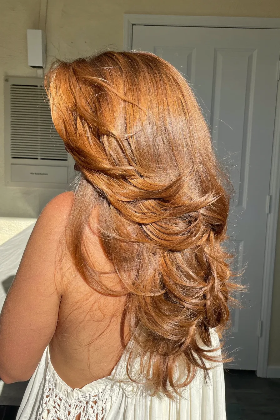 Voluminous Long Layered Cut with Warm Copper Red Hue