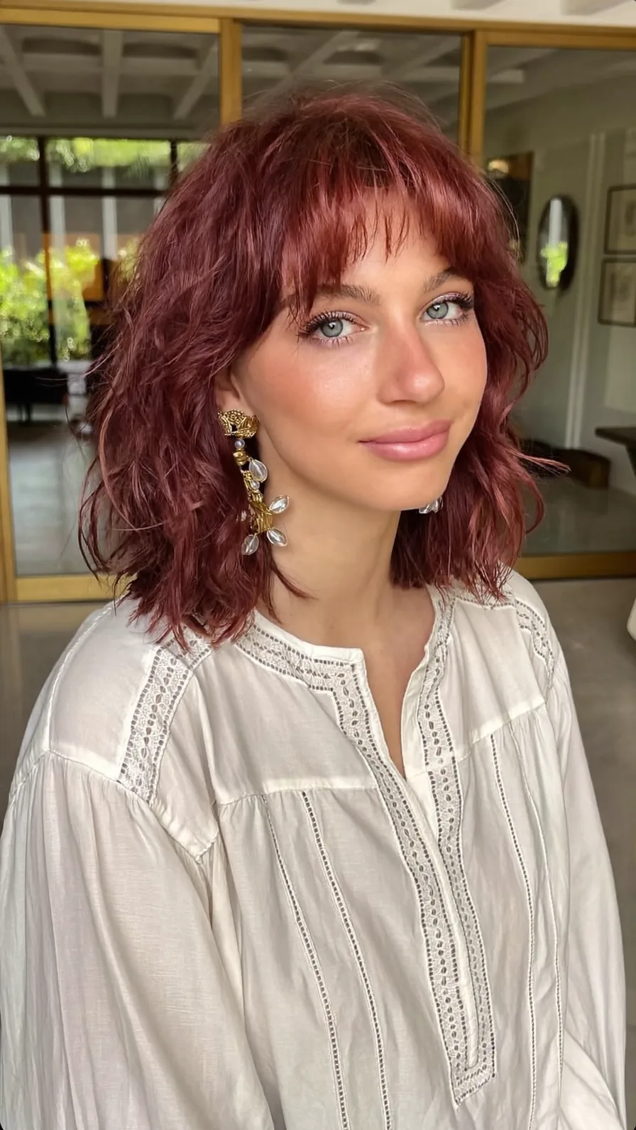 Textured Chin-Length Auburn Waves with Wispy Bangs