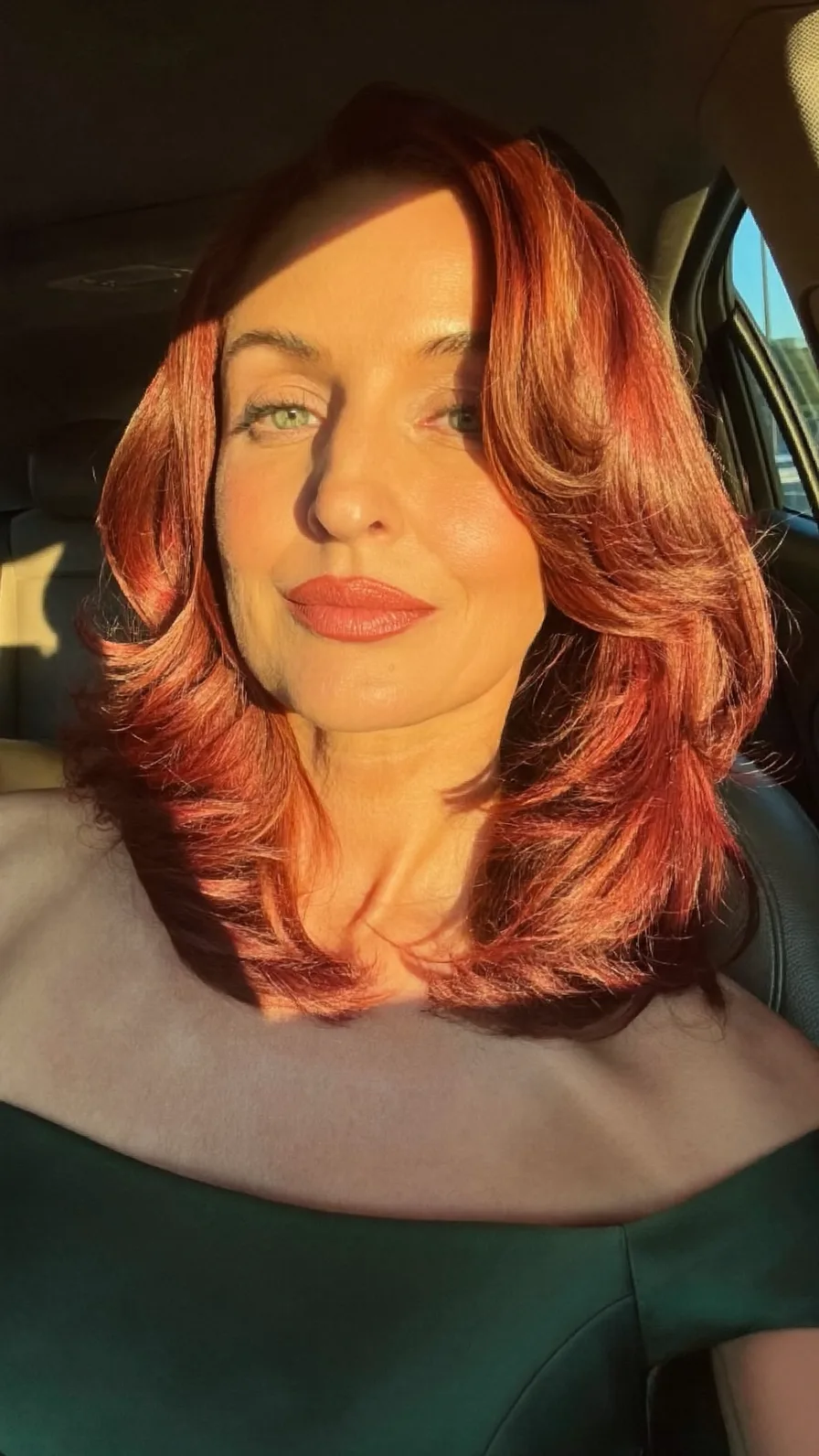 Voluminous Copper Red Long Layers with Side-Swept Styling