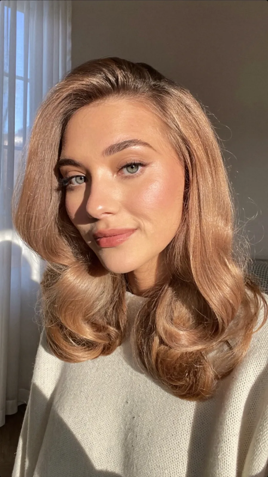 Voluminous Medium Length Rose Gold Blonde Wavy Layers