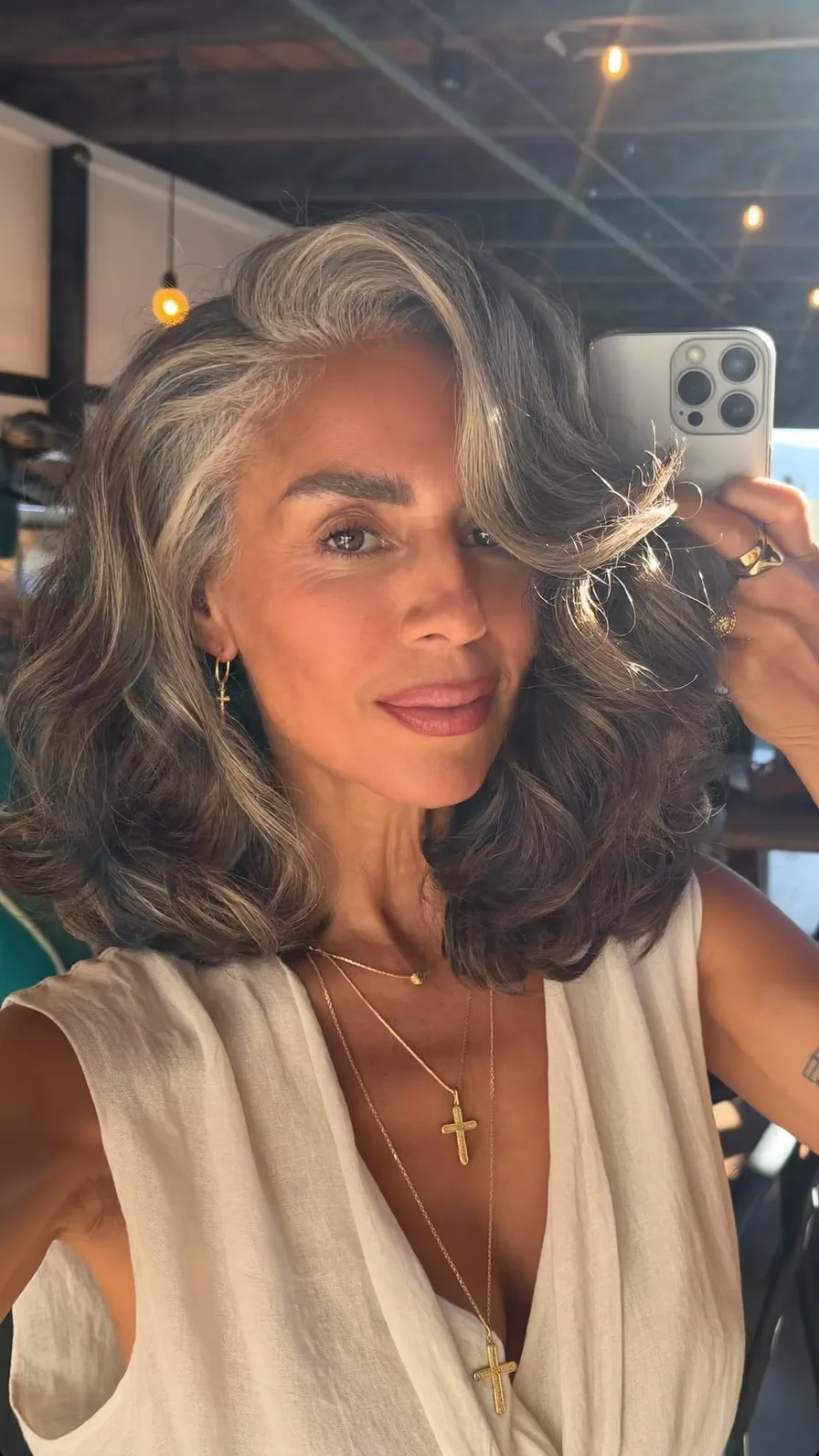Voluminous Salt and Pepper Long Layers with Side-Swept Bangs