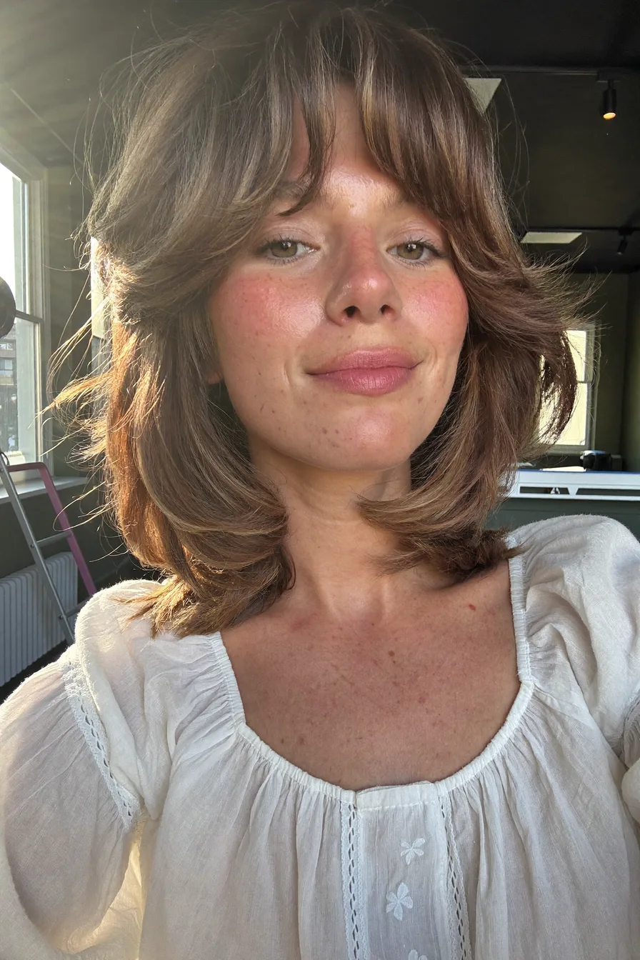 Shoulder-Length Feathered Shag with Face-Framing Bangs