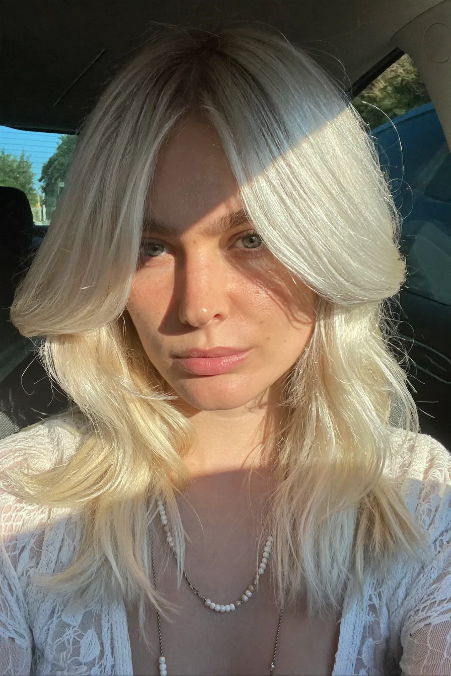Textured Platinum Shag Haircut with Voluminous Curtain Bangs