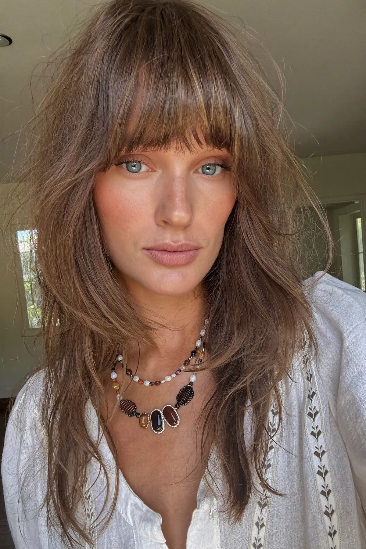 Collarbone-Length Dark Blonde Shag with Full Fringe Bangs