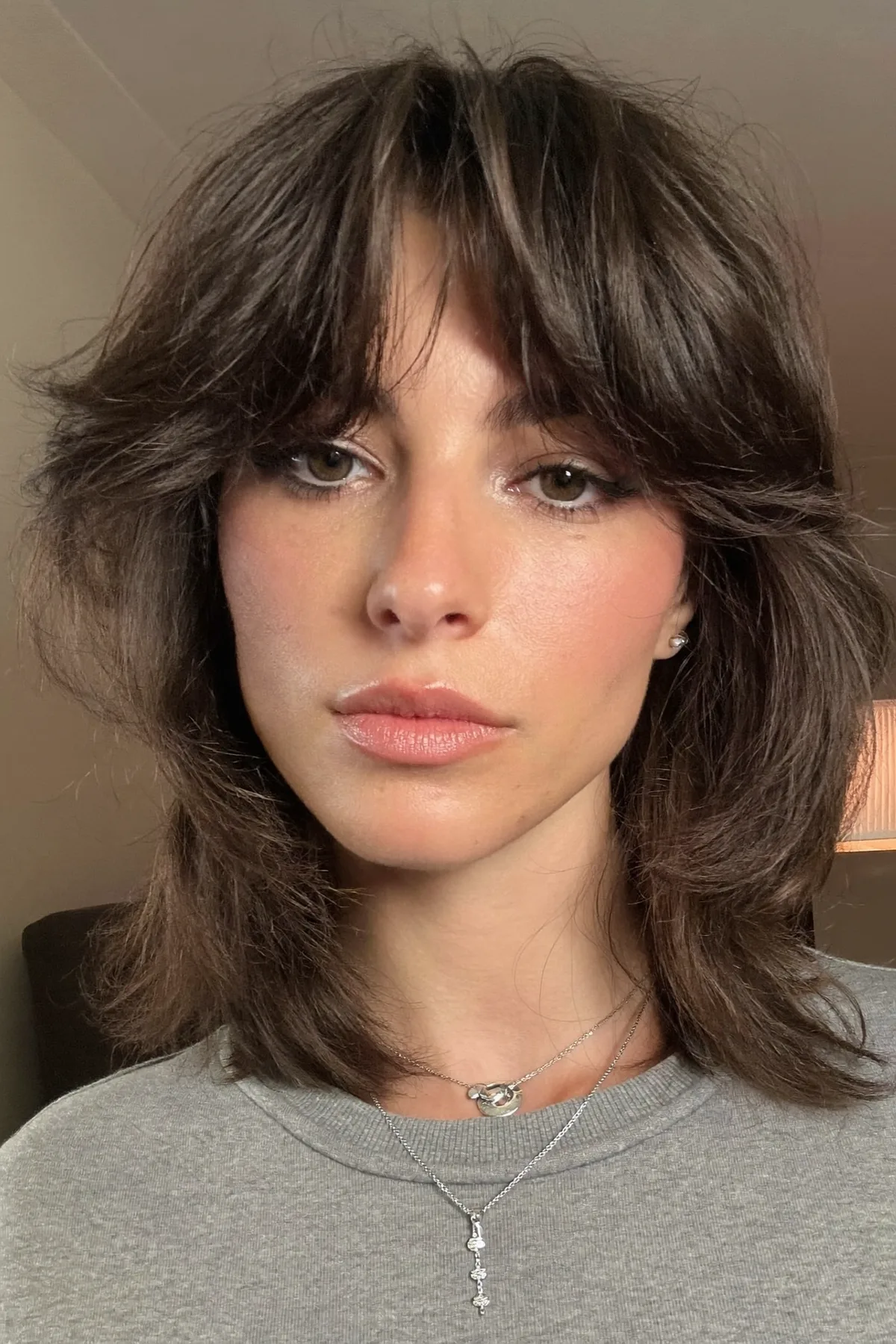 Collarbone-Length Natural Brunette Shag with Curtain Bangs