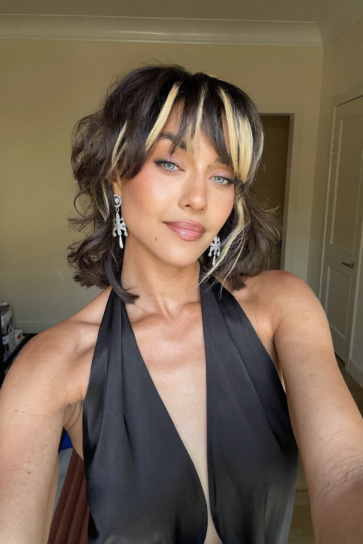 Shoulder-Length Natural Brunette Shag with Curtain Bangs and Chunky Highlights