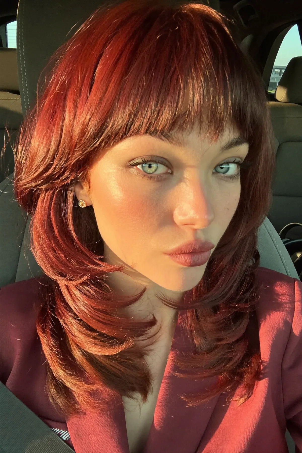 Vivid Red Collarbone-Length Shag with Full Fringe Bangs
