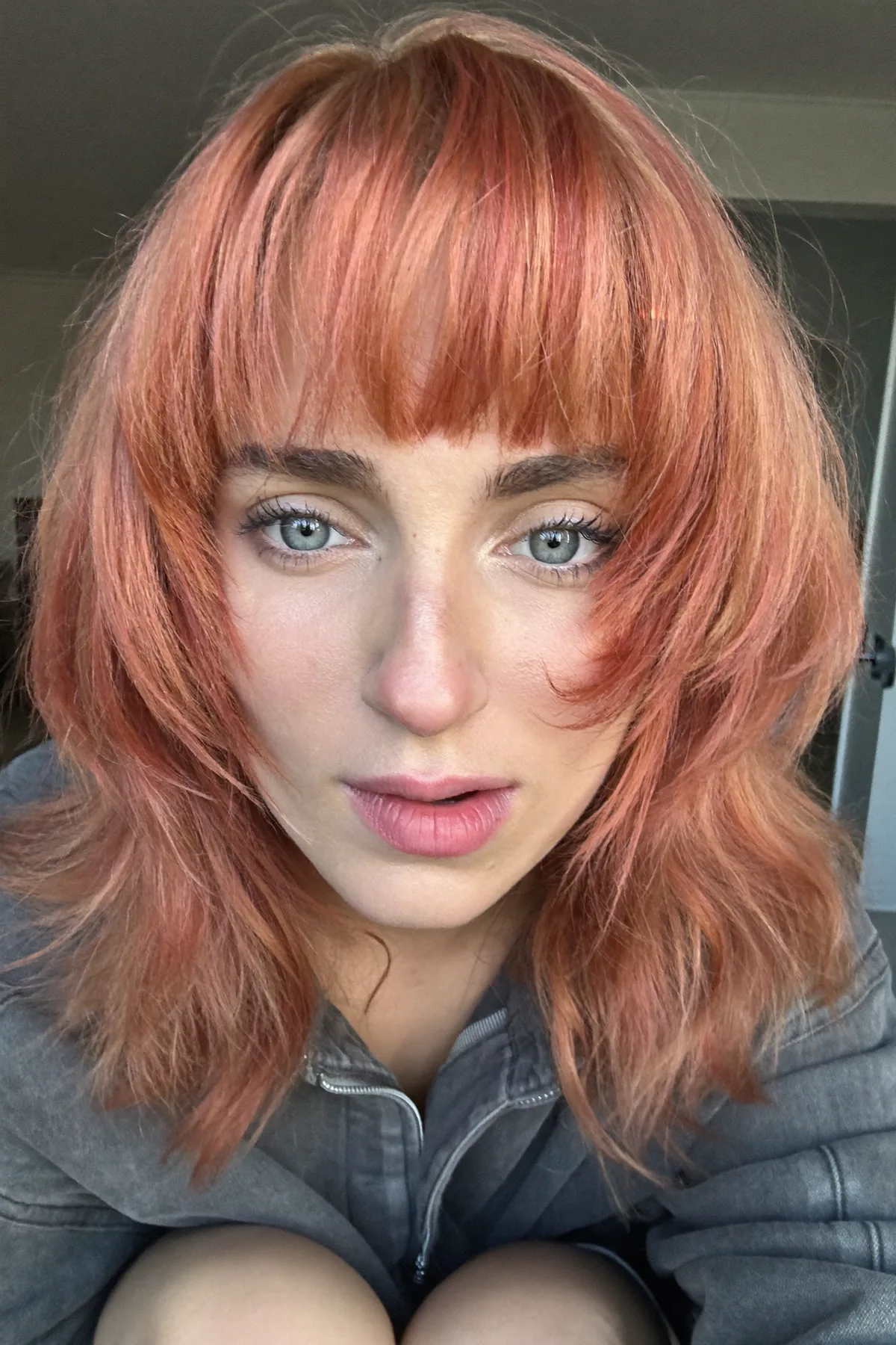 Shoulder-Length Strawberry Blonde Shag with Full Fringe Bangs