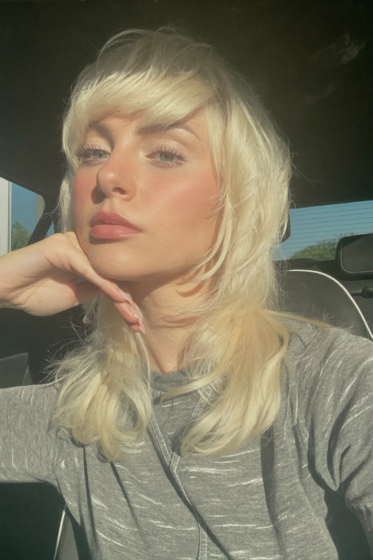 Platinum Ash Blonde Collarbone-Length Shag with Full Fringe Bangs