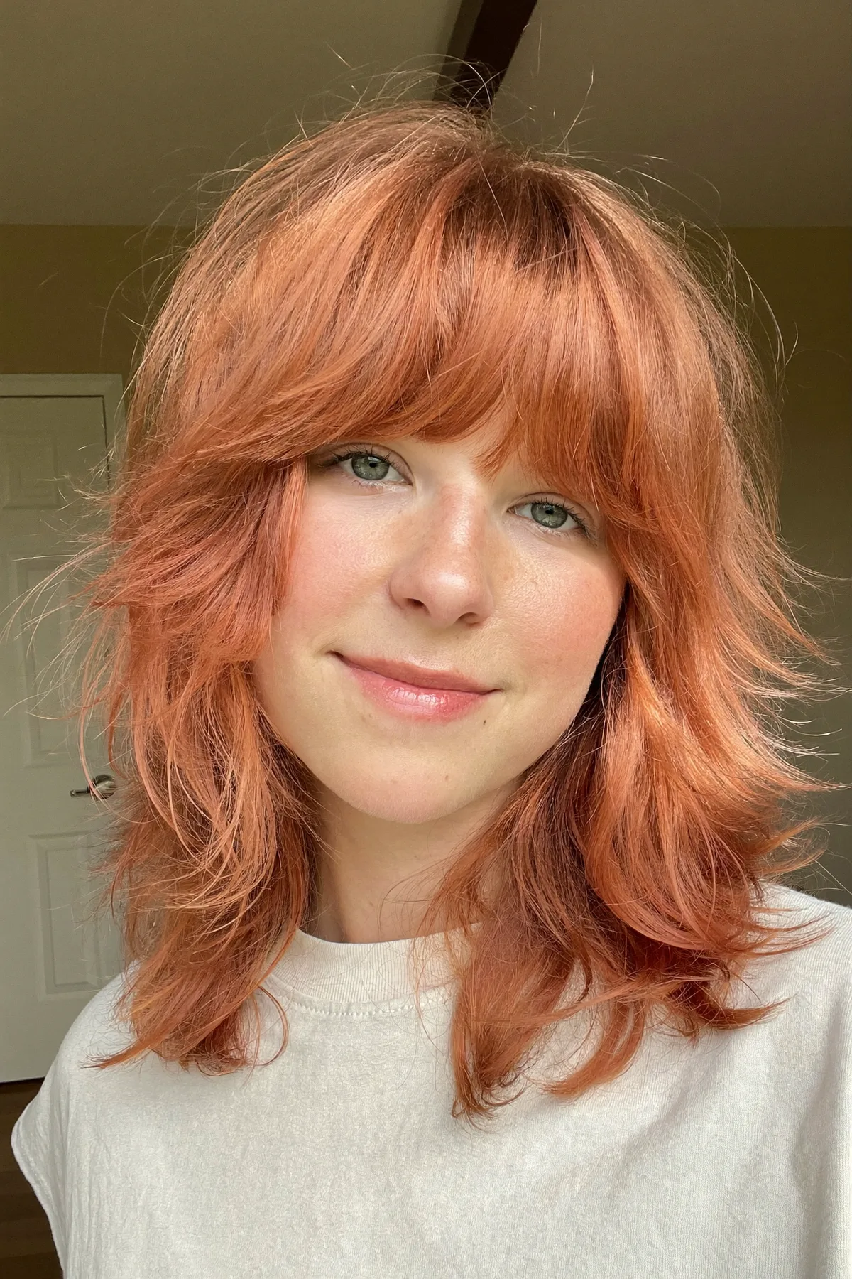 Collarbone-Length Strawberry Blonde Shag with Full Fringe Bangs