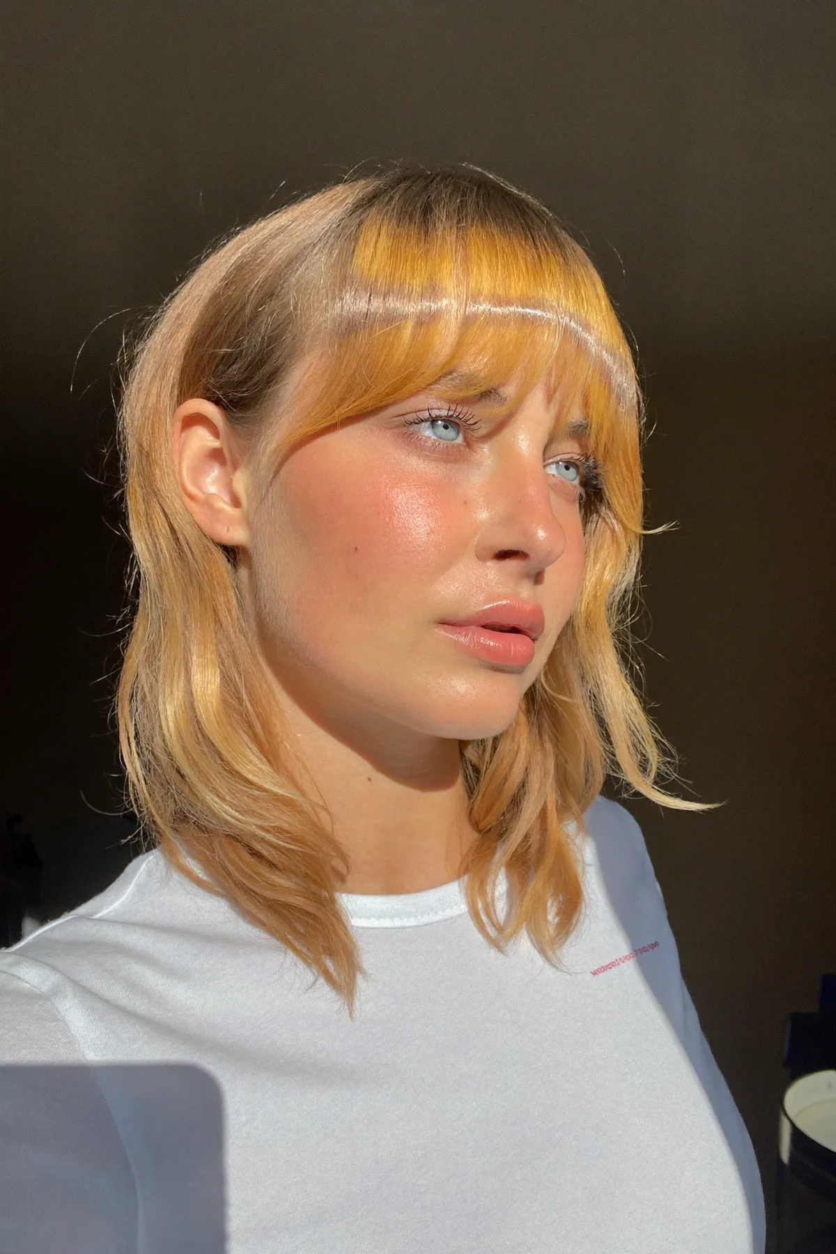 Shoulder-Length Strawberry Blonde Shag with Full Fringe Bangs