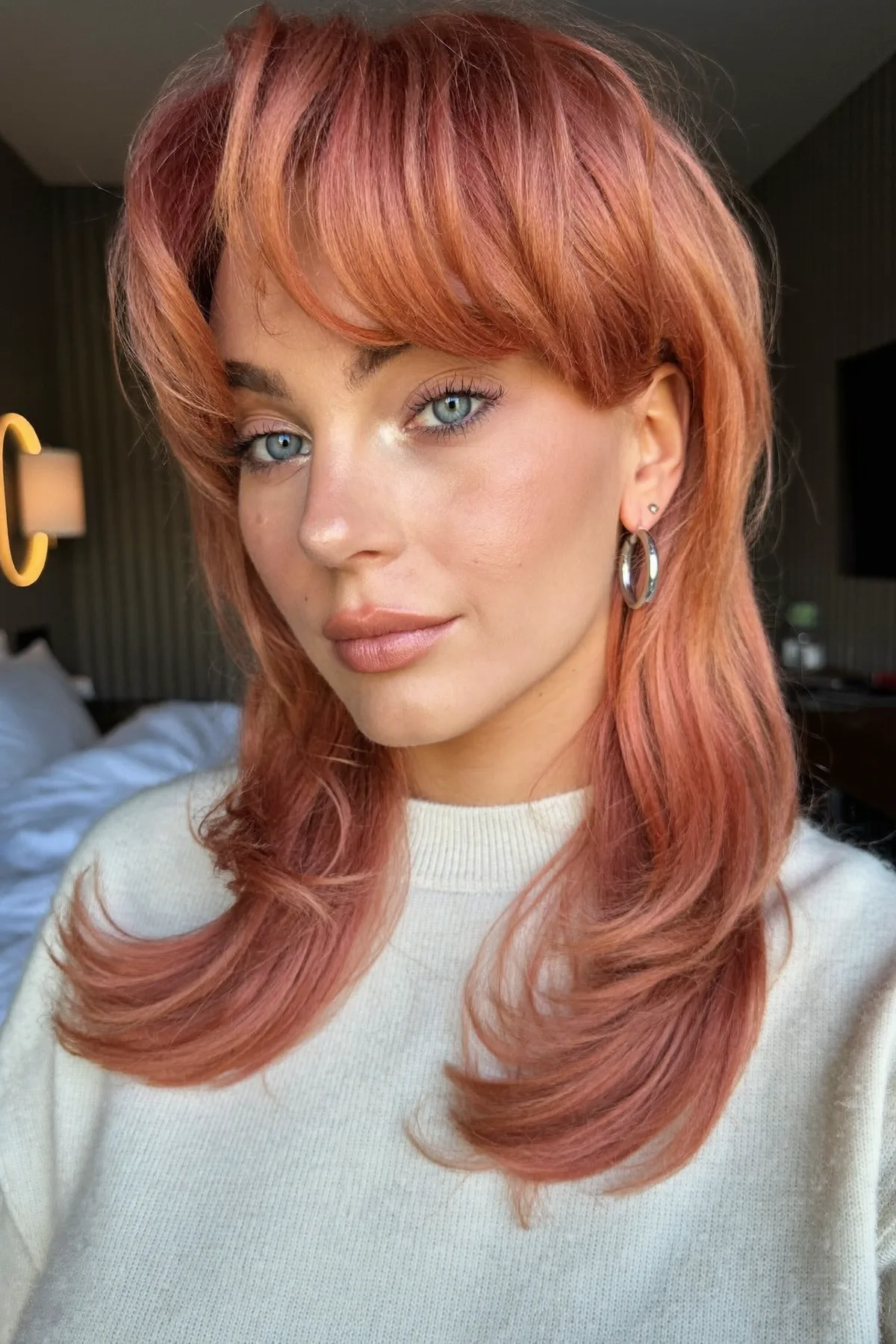 Collarbone-Length Strawberry Blonde Shag with Curtain Bangs