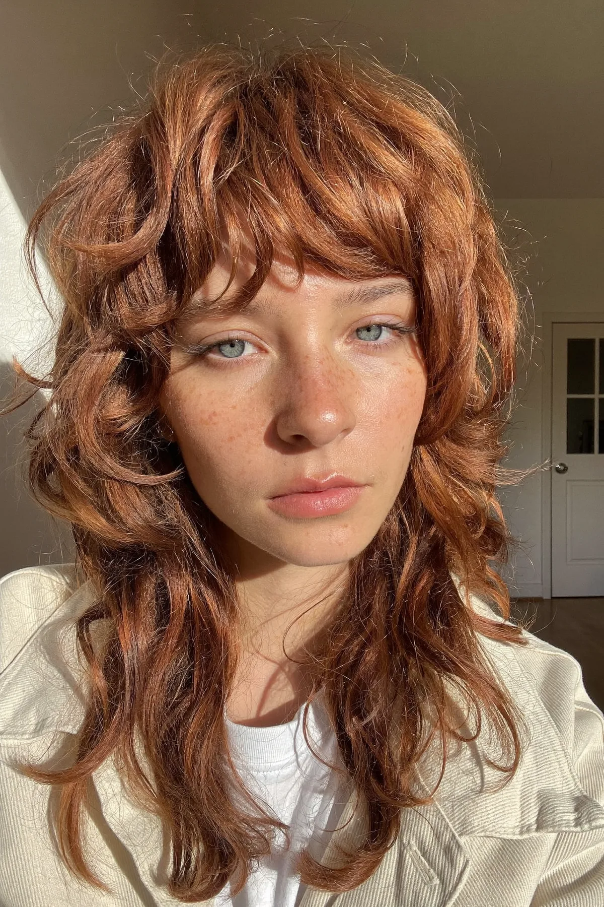 Collarbone-Length Strawberry Blonde Shag with Curtain Bangs