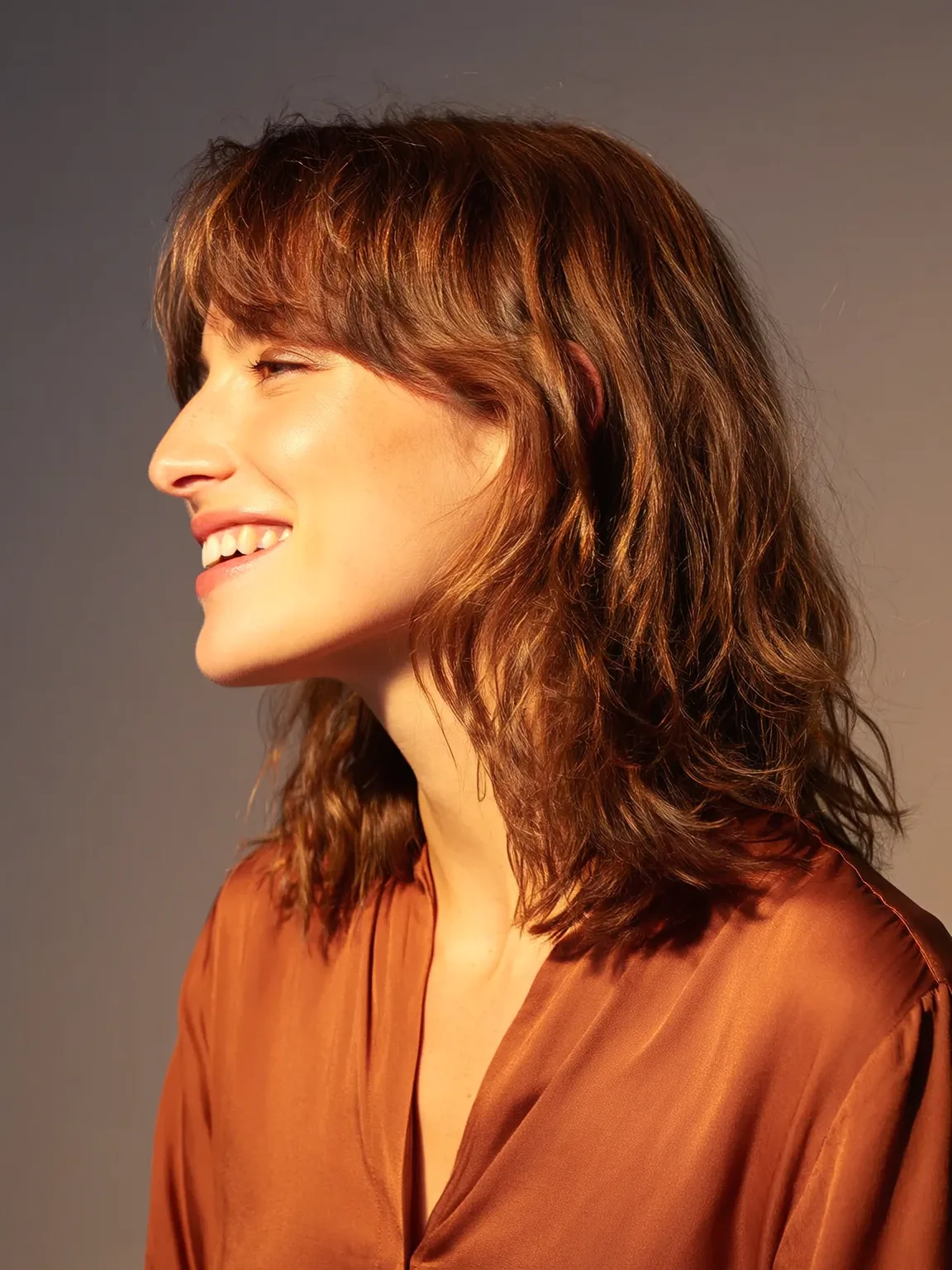 Medium-Length Warm Copper Shag with Soft Curtain Bangs