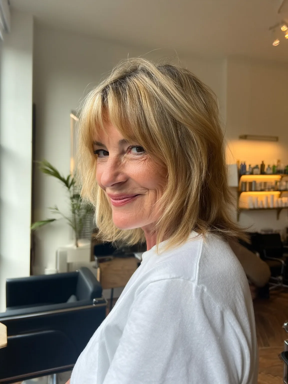 Sandy Blonde Chin-Length Wavy Shag with Wispy Bangs