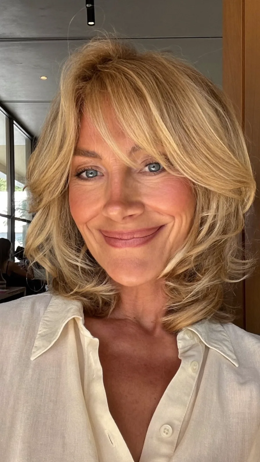 Voluminous Golden Blonde Layered Lob with Feathered Curtain Bangs