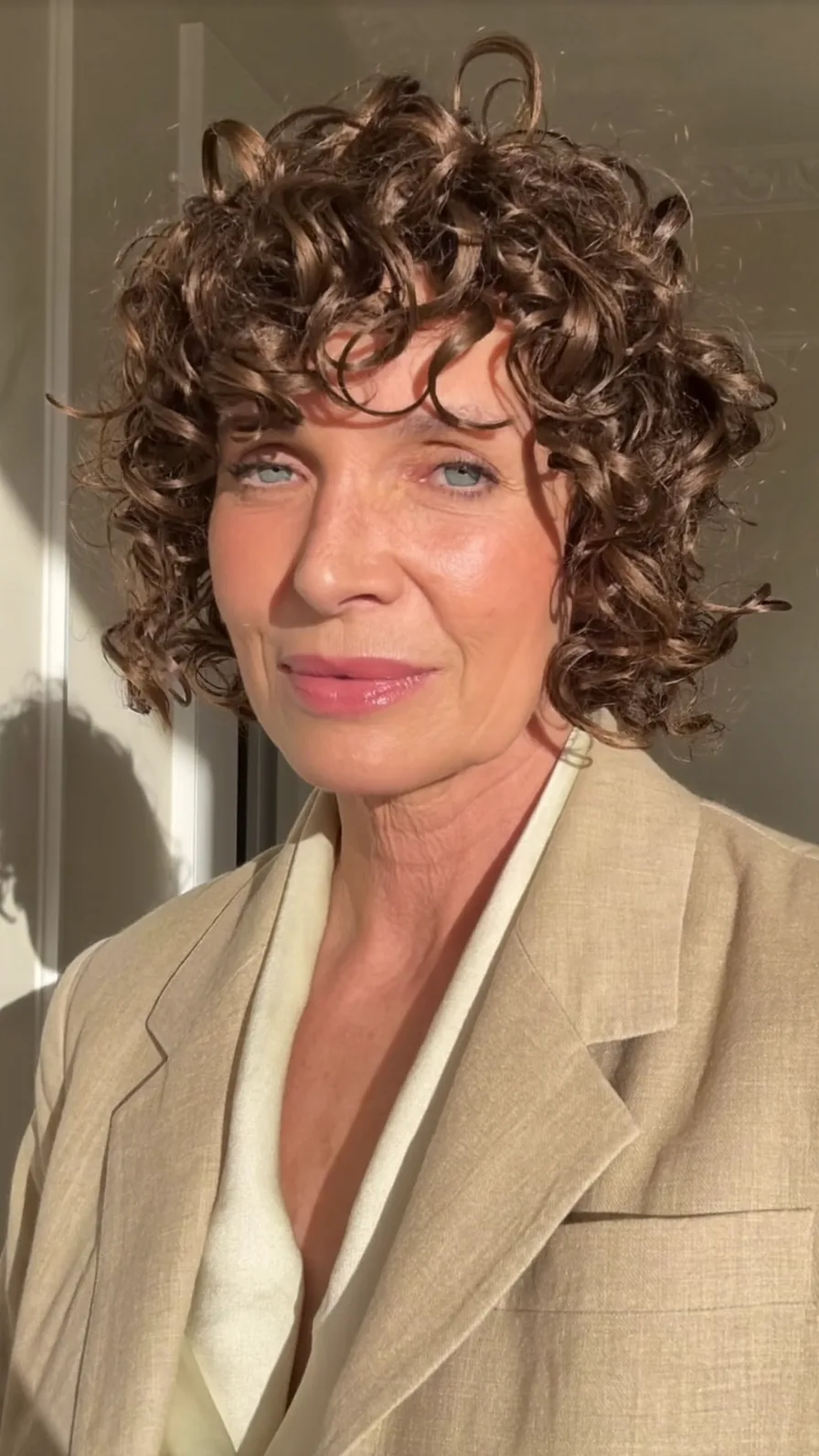 Voluminous Short Curly Bob with Curtain Bangs for Older Women