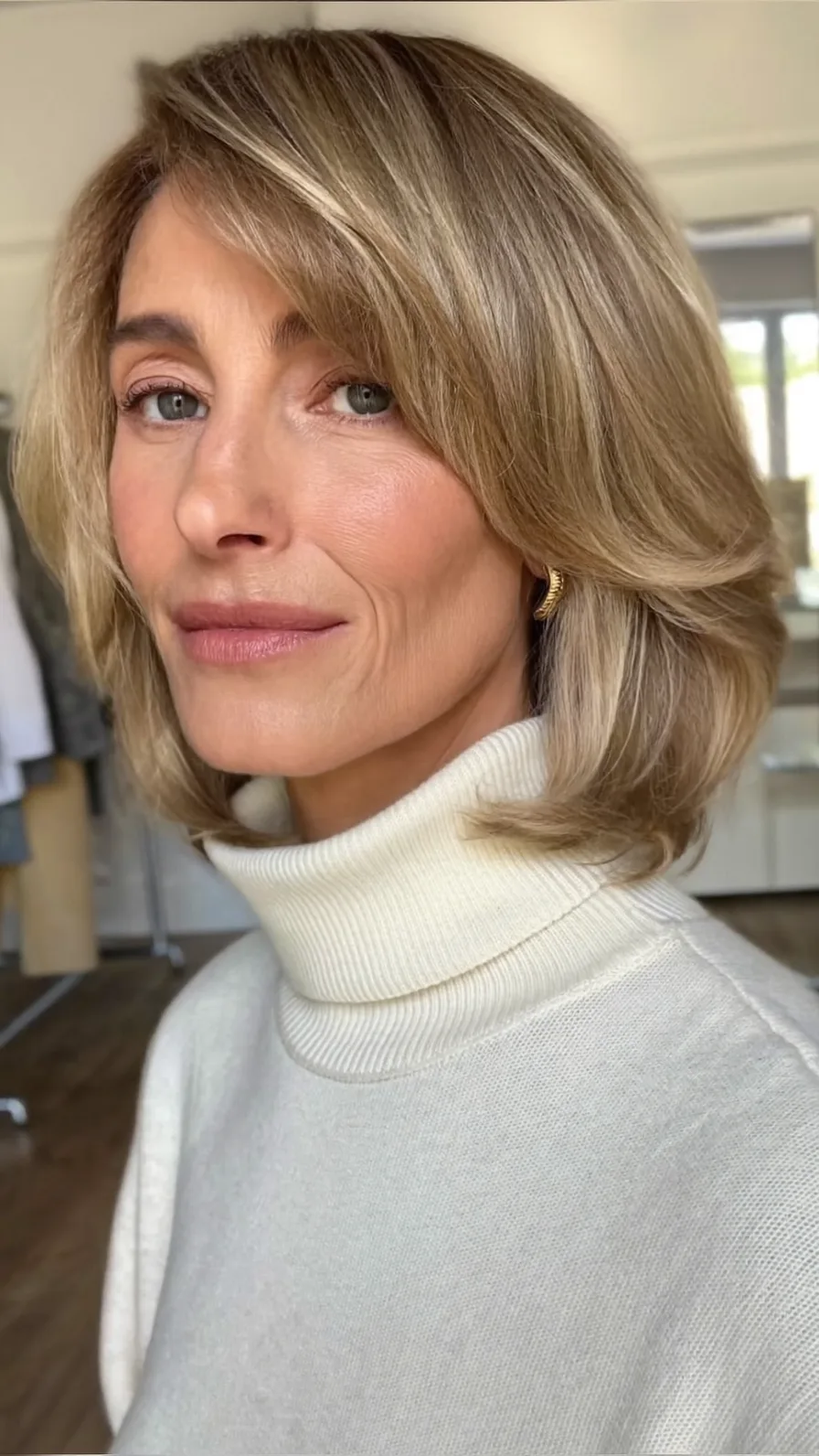 Sophisticated Layered Shoulder-Length Blowout with Side-Swept Bangs