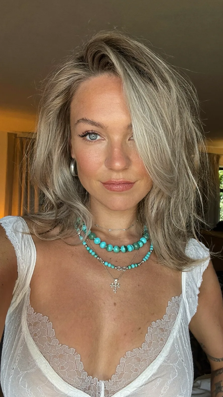 Voluminous Layered Ash Blonde Shoulder-Length Hair with Side Bangs