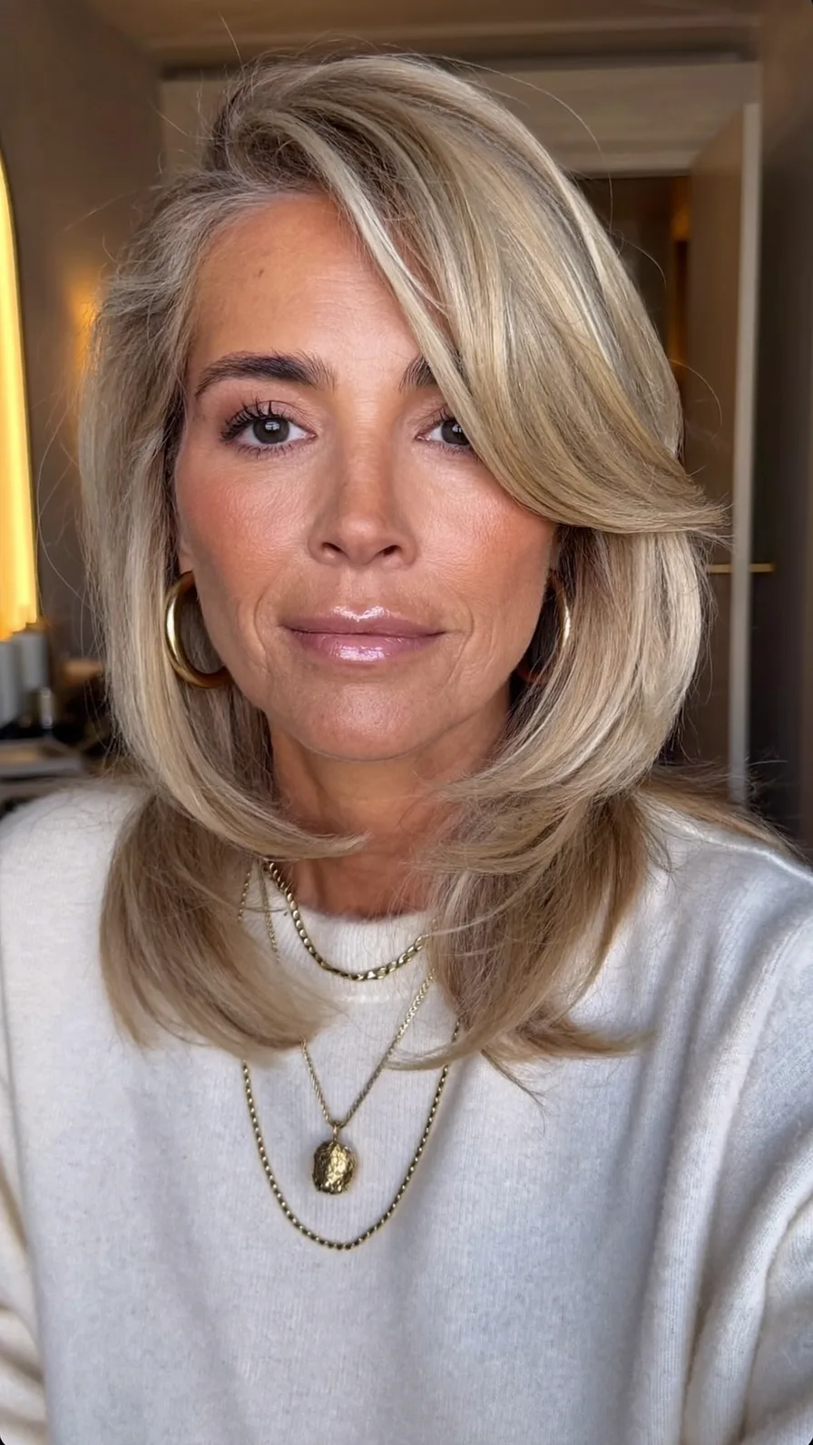 Voluminous Shoulder-Length Layers with Side-Swept Feathered Ends