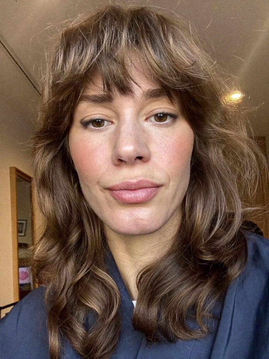 Textured Long Layers with Wispy Bangs and Subtle Highlights