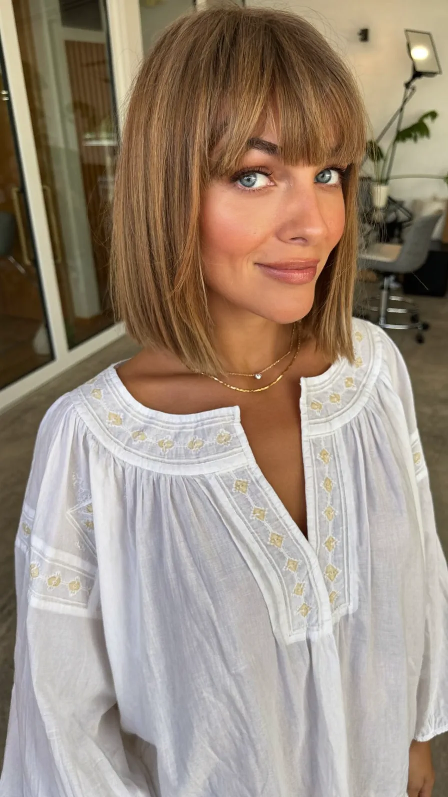 Shoulder-Length Warm Caramel Brown Blunt Bob with Blunt Bangs